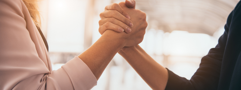 Partnership Two people shake hands.