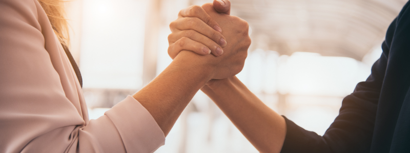 Two people shake hands. 