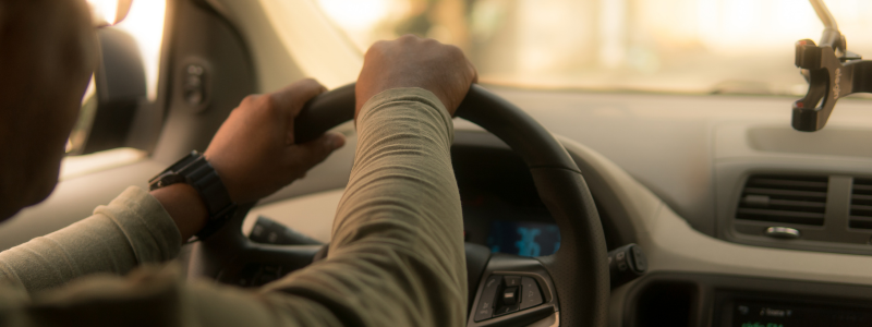 A close up of someone driving their car. 