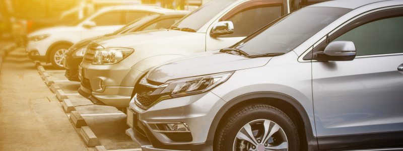 The fronts of a row of cars alongside one another.