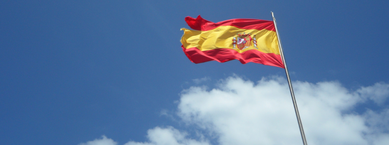 A Spanish flag flying in the wind.