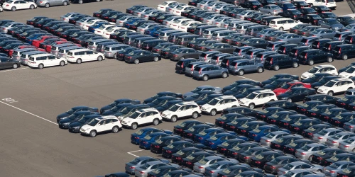 An aerial view of hundreds of cars in a lot.