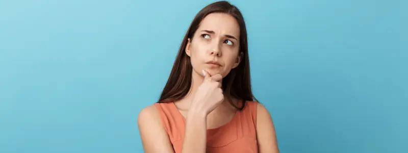 Thinking Face A woman in thought looking to one side, against a light blue background.
