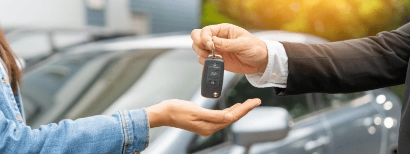 Car keys being passed over, representing a change of car ownership.