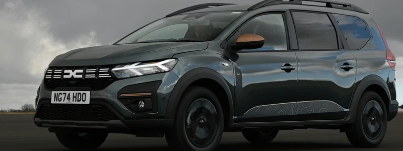 A black Dacia Jogger against a dark background.