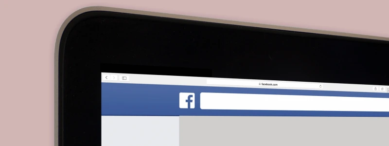 A Facebook search bar on a laptop device.