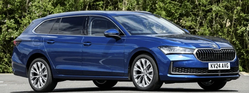 A blue Skoda Superb Estate parked up.