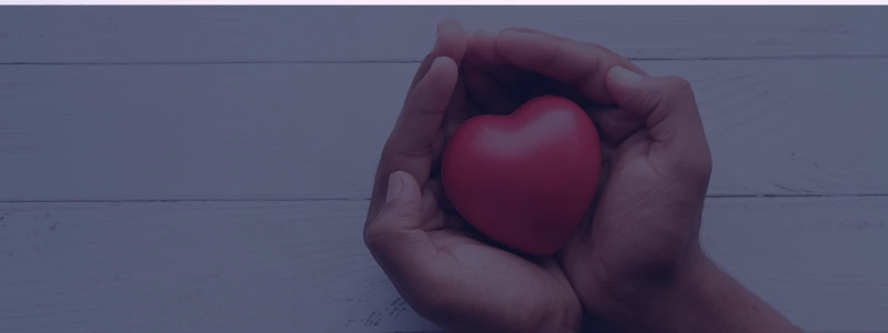 Hands holding a heart.