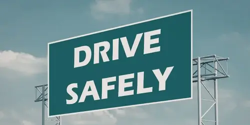 A drive safely sign on top of a stanchion.