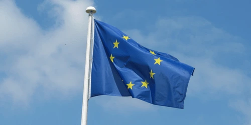 A European Union flag waving in the wind.