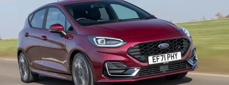 A purple Ford Fiesta on a rural road.