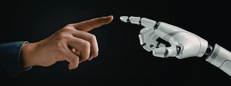 A human finger close to touching a robot's finger.
