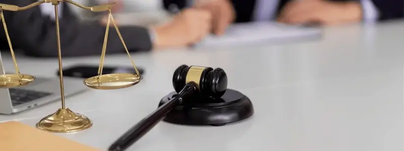 A business meeting with law instruments on the desk.