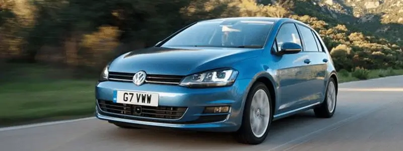 A blue VW Golf on a rural road.