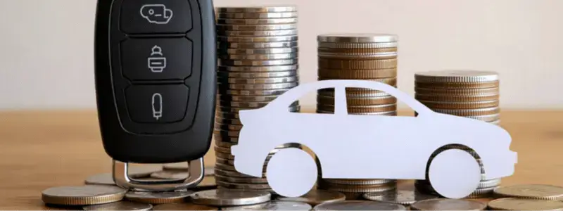 A car outline and keys in front of cars, representing car finance.