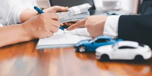 A handover of cash next to a contract signing for cars.