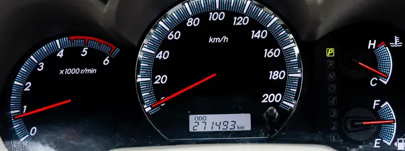 A close up of a cars odometre.