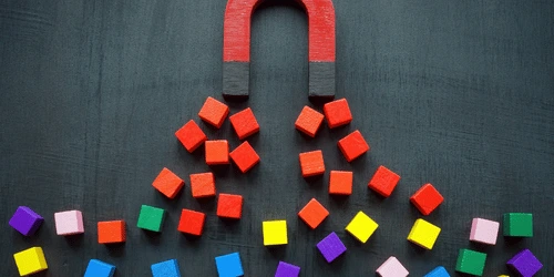 A magnet attracting cubes.