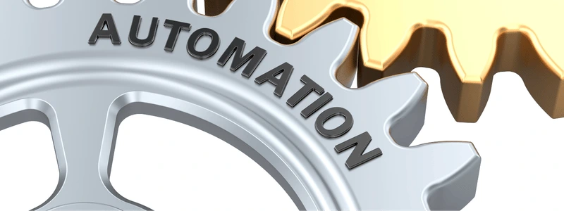 A grey cog joined onto a gold cog, with the grey one having 'AUTOMATION' written on it.