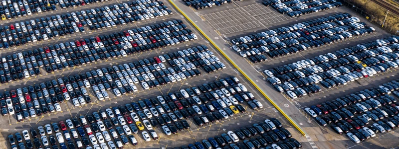 A mostly full car lot, taken from above. 