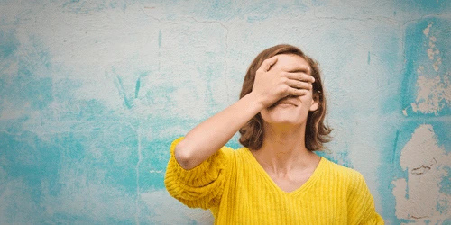 A person hiding their face in stress.